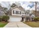 Well-manicured front lawn on two-story home with a two-car garage and vinyl siding at 122 Moon Shadow Ln, Summerville, SC 29485