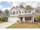 Charming two-story home featuring a well-maintained front yard, white garage door, and vinyl siding at 122 Moon Shadow Ln, Summerville, SC 29485