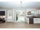 Kitchenette area offering stainless dishwasher, white cabinets, and backyard views via sliding glass door at 122 Moon Shadow Ln, Summerville, SC 29485