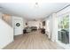 Bright living room with new floors, cozy seating, natural light, and access to the backyard at 122 Moon Shadow Ln, Summerville, SC 29485