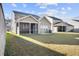 The home features a spacious backyard with well-maintained lawn and screened porch at 128 Surfbird Rd, Summerville, SC 29486