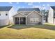 View of spacious backyard and screened in porch, a comfortable space to unwind at 128 Surfbird Rd, Summerville, SC 29486
