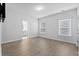 Bedroom features hardwood floors, natural lighting, and an ensuite bathroom at 128 Surfbird Rd, Summerville, SC 29486