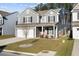 Charming two-story home with gray siding, well-manicured lawn, and a two car attached garage at 128 Surfbird Rd, Summerville, SC 29486