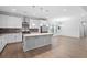 Spacious open-concept kitchen with stainless appliances, gray backsplash, and center island at 128 Surfbird Rd, Summerville, SC 29486