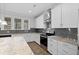 Bright kitchen with granite countertops, stainless appliances, and white cabinetry at 128 Surfbird Rd, Summerville, SC 29486