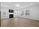Bright living room features a cozy fireplace, laminate flooring, and natural light at 128 Surfbird Rd, Summerville, SC 29486