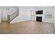 Bright living room features wood floors, fireplace, and stairs to the second level at 128 Surfbird Rd, Summerville, SC 29486