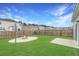 Spacious backyard features a fire pit area, concrete patio, green grass, and wooden fence at 131 Horizon Ridge Dr, Summerville, SC 29486