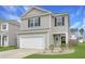 Charming two-story home with gray siding, attached garage, and landscaped front yard for appealing curb appeal at 131 Horizon Ridge Dr, Summerville, SC 29486