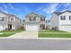 Charming two-story home with a gray exterior, white garage door, driveway, and manicured lawn at 131 Horizon Ridge Dr, Summerville, SC 29486