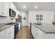 Modern kitchen features white cabinetry, granite countertops, and stainless steel appliances at 131 Horizon Ridge Dr, Summerville, SC 29486