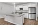 Open concept kitchen features white cabinets, granite countertops, stainless steel appliances and a large island at 131 Horizon Ridge Dr, Summerville, SC 29486