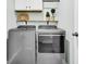 The laundry room has new front load machines and convenient storage shelves at 131 Horizon Ridge Dr, Summerville, SC 29486