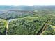 Aerial shot featuring wooded acreage with defined boundaries and a picturesque pond enhancing the natural setting at 13959 Cottageville Hwy, Cottageville, SC 29435