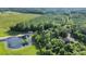 An aerial view shows property with a private pond, adjacent cabin, and surrounding mature trees at 13959 Cottageville Hwy, Cottageville, SC 29435
