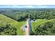 Scenic aerial shot captures the property's private pond and the lush greenery of surrounding forests at 13959 Cottageville Hwy, Cottageville, SC 29435