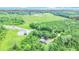 This beautiful aerial view features a serene pond surrounded by lush greenery, along with a charming house nestled in the trees at 13959 Cottageville Hwy, Cottageville, SC 29435