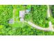 Aerial view of property showcasing a home with outbuildings, surrounded by mature trees at 13959 Cottageville Hwy, Cottageville, SC 29435