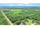 Expansive aerial view showing property boundaries, road access, and diverse landscape of wooded and open areas at 13959 Cottageville Hwy, Cottageville, SC 29435