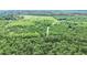 This aerial shot captures a property with a mix of open fields and wooded areas, ideal for development or recreation at 13959 Cottageville Hwy, Cottageville, SC 29435