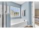 Bathroom featuring a soaking tub with tile backsplash and fixtures at 146 Education Blvd, Ladson, SC 29456