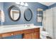 Charming bathroom with dual mirrors, white vanity and shower with curtain at 146 Education Blvd, Ladson, SC 29456