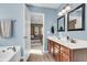 Bathroom with double vanity, soaking tub, and open view to the bedroom at 146 Education Blvd, Ladson, SC 29456