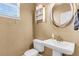 Cozy bathroom features a pedestal sink, toilet, decorative shelving, and a neutral color palette at 146 Education Blvd, Ladson, SC 29456