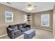 Bedroom with a sofa, ottoman, carpeted floor, and natural light from three windows at 146 Education Blvd, Ladson, SC 29456