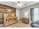 Stylish Bedroom featuring wood accent wall, crib, and charming decor at 146 Education Blvd, Ladson, SC 29456