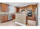 Spacious kitchen with modern stainless steel appliances, dark wood cabinets, and breakfast bar at 146 Education Blvd, Ladson, SC 29456