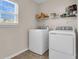 Functional laundry room featuring washer, dryer and shelving at 146 Education Blvd, Ladson, SC 29456