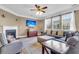 Bright living room with fireplace, ceiling fan, large windows, and comfortable seating area with large sectional at 146 Education Blvd, Ladson, SC 29456