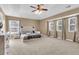 Large main bedroom features tray ceiling, carpeting, and multiple windows for natural light at 146 Education Blvd, Ladson, SC 29456