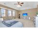 Bright, large main bedroom with tray ceiling, ample windows, and exercise bike at 146 Education Blvd, Ladson, SC 29456