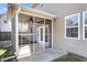 Close up of screened in porch features tiled flooring, ceiling fan, and access to the backyard at 146 Education Blvd, Ladson, SC 29456