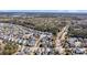 An aerial view of a planned community, showcasing the neighborhood layout with tree-lined streets and proximity to a wooded area at 1525 Harriman St, Mount Pleasant, SC 29466