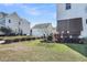Backyard view shows mature trees, grass, and other homes at 1525 Harriman St, Mount Pleasant, SC 29466