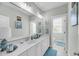 Bright bathroom with double sinks, white cabinetry, and a large mirror with overhead lighting at 1525 Harriman St, Mount Pleasant, SC 29466