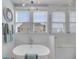 Bright bathroom features a soaking tub, glass-enclosed shower, and stylish light fixture at 1525 Harriman St, Mount Pleasant, SC 29466