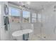 Bright bathroom features a soaking tub, glass-enclosed shower, and stylish light fixture at 1525 Harriman St, Mount Pleasant, SC 29466