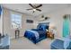Nautical themed bedroom features a surfboard decoration and vibrant blue bedding accents at 1525 Harriman St, Mount Pleasant, SC 29466