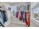 Walk-in closet with organized storage solutions and natural light from two windows at 1525 Harriman St, Mount Pleasant, SC 29466