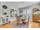 Cozy dining room features a round table, wood floors, and ample natural light from surrounding windows at 1525 Harriman St, Mount Pleasant, SC 29466
