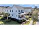 Two-story home featuring a metal roof porch, lush landscaping, and nearby palm trees on a sunny day at 1525 Harriman St, Mount Pleasant, SC 29466