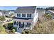 A two-story home with a welcoming front porch, dark shutters, and a manicured yard on a sunny day at 1525 Harriman St, Mount Pleasant, SC 29466