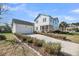 Charming two-story white home with a detached garage, screened porch, and a well-manicured lawn at 1525 Harriman St, Mount Pleasant, SC 29466