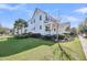 Spacious home with a front porch, manicured lawn, and mature trees on a sunny day at 1525 Harriman St, Mount Pleasant, SC 29466