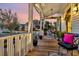 Inviting front porch with stylish furniture, decorative plants, and a welcoming ambiance under the covered ceiling at 1525 Harriman St, Mount Pleasant, SC 29466